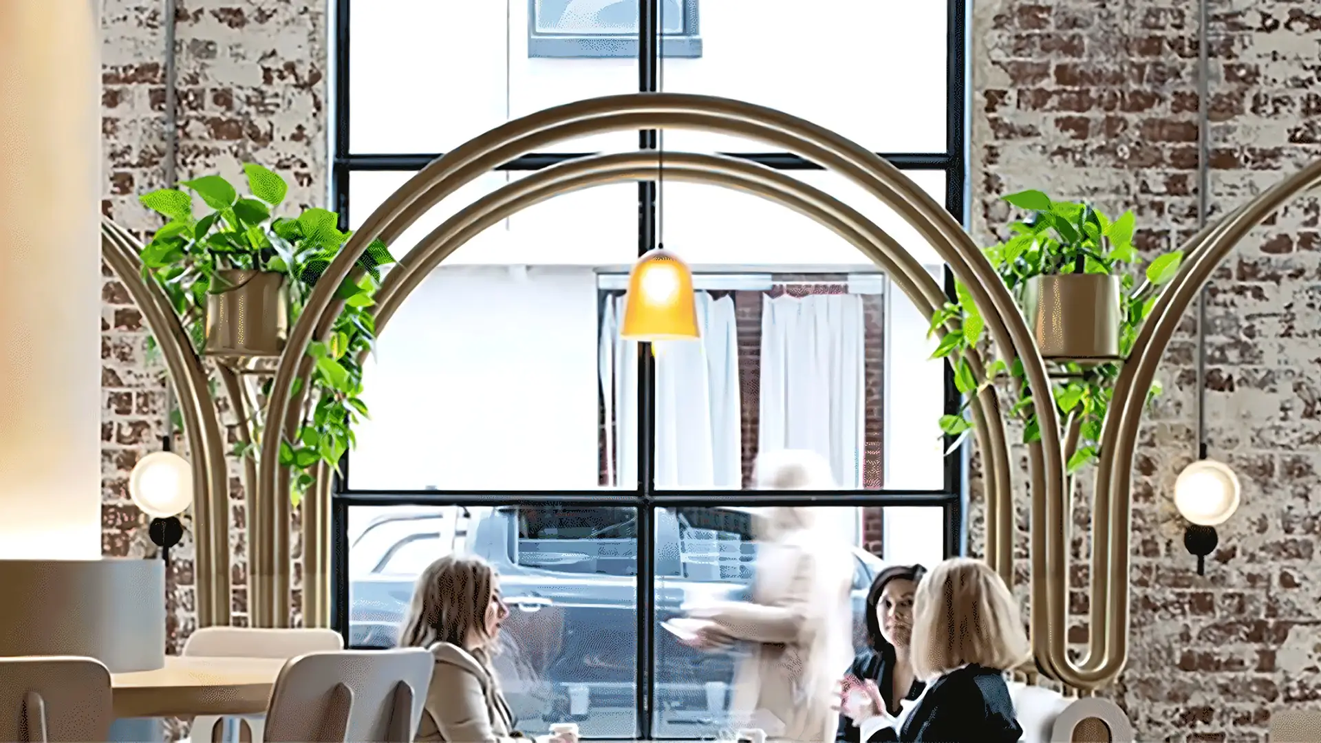 Reece New Global HQ office in Melbourne employees sitting around under the Softscape Pendant Lamp designed by Helen Kontouris of LEN.